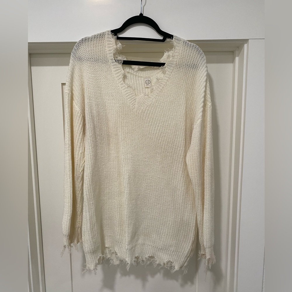 Distressed hem sweater